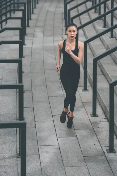 Sportswoman training on stadium stairs — Stock Photo