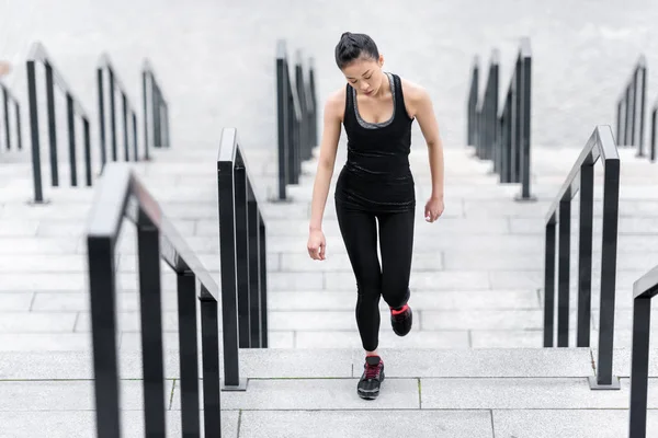 Sportswoman training on stadium stairs — Stock Photo