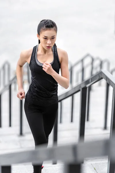 Sportswoman training on stadium stairs — Stock Photo