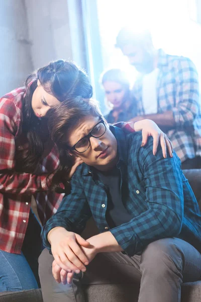 Woman supporting male friend — Stock Photo