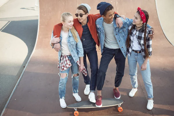 Teenagers spending time at skateboard park — Stock Photo