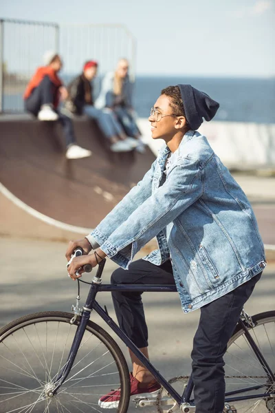 Hipster boy riding bicycle — Stock Photo