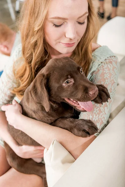 Woman holding puppy — Stock Photo