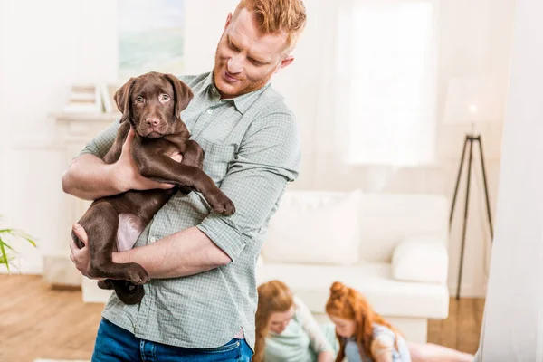 Father holding puppy — Stock Photo