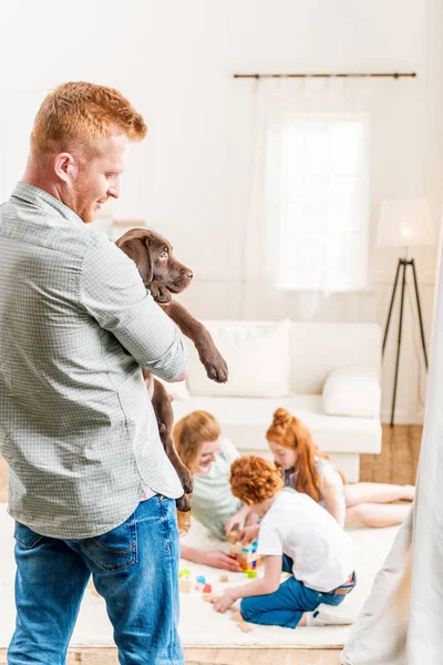 Father holding puppy — Stock Photo
