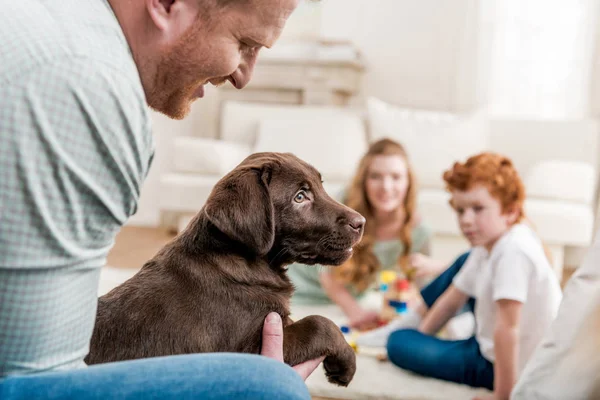 Father holding puppy — Stock Photo