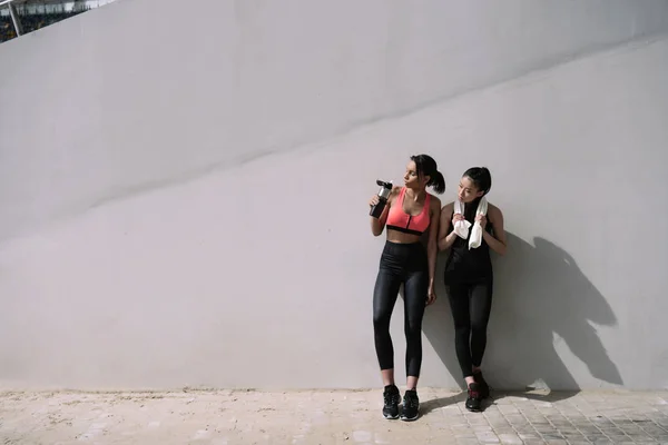 Sportswomen resting on stadium — Stock Photo