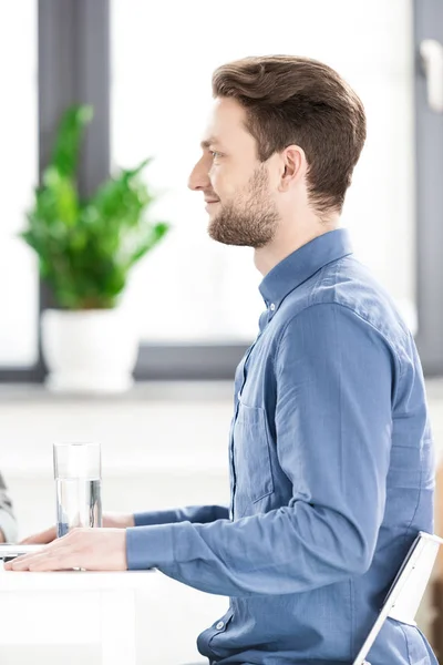 Businessman sitting at desk — Stock Photo