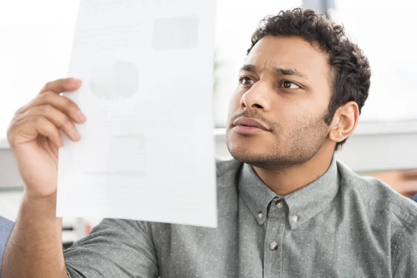 Businessman looking at document — Stock Photo