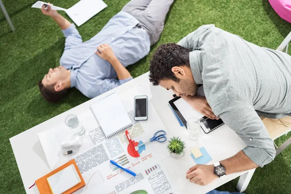 Businessmen sleeping at modern office — Stock Photo