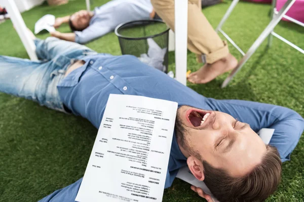 Businessmen sleeping at modern office — Stock Photo