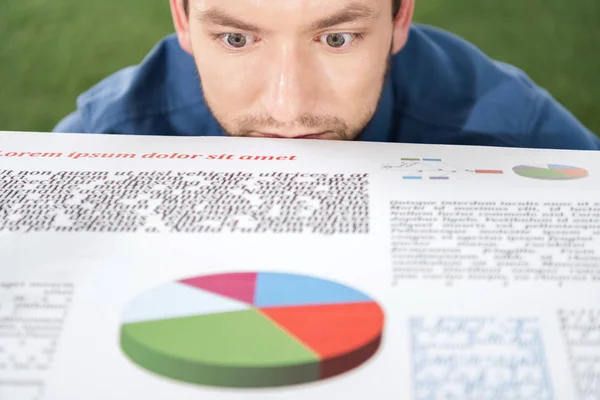 Businessman looking at documents with charts and diagrams — Stock Photo