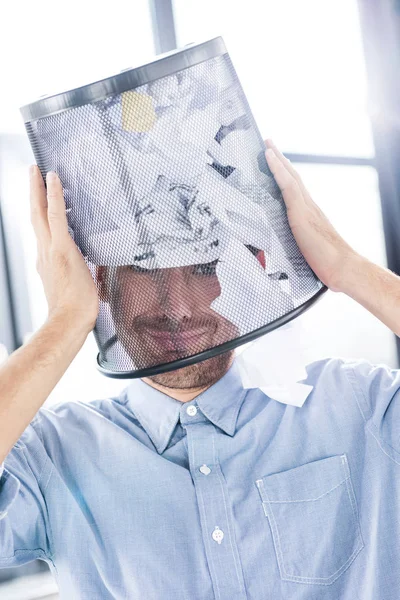 Businessman with trash bucket on head — Stock Photo