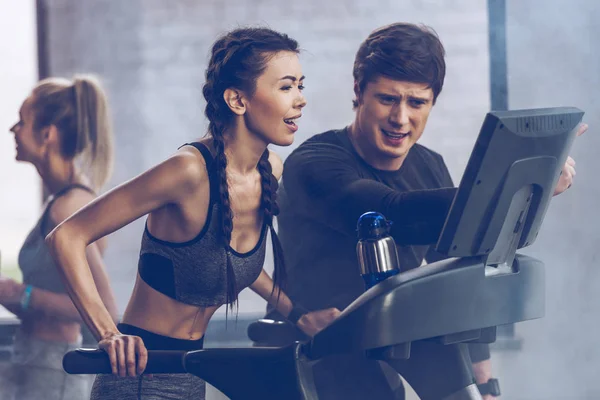 Sportswoman running on treadmill — Stock Photo