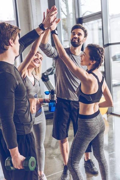 Sporty people giving high five — Stock Photo