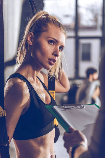 Sportive woman with trx equipment — Stock Photo