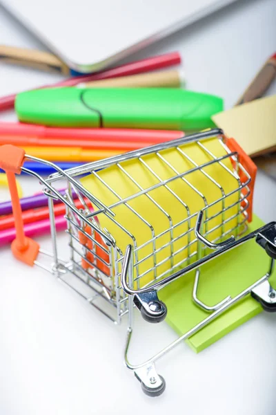 School supplies in shopping cart — Stock Photo