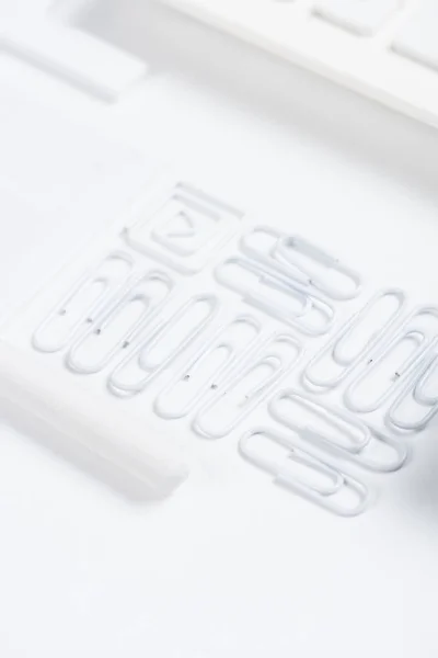 Arranged white clips — Stock Photo