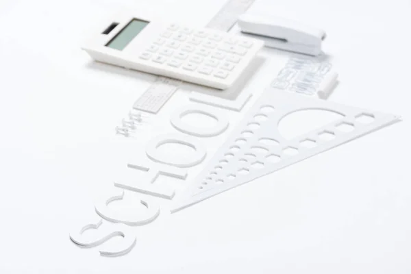 Calculator with rulers and stapler with compasses — Stock Photo