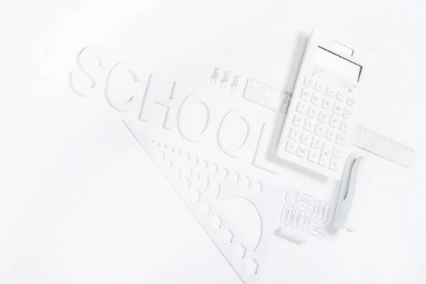 Calculator with rulers and stapler with compasses — Stock Photo