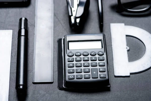 Calculator with various office utensils — Stock Photo