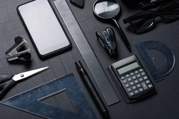 Smartphone with various office utensils — Stock Photo