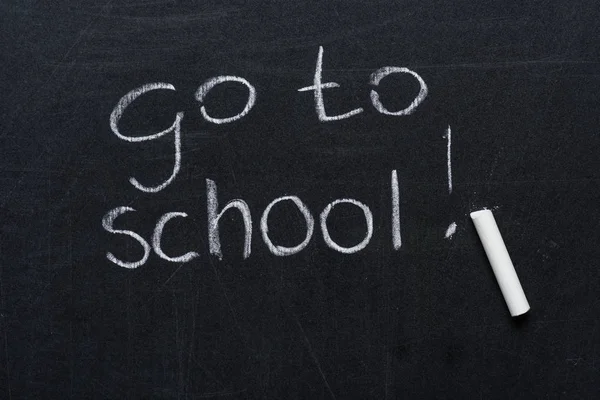 Phrase go to school with piece of chalk — Stock Photo