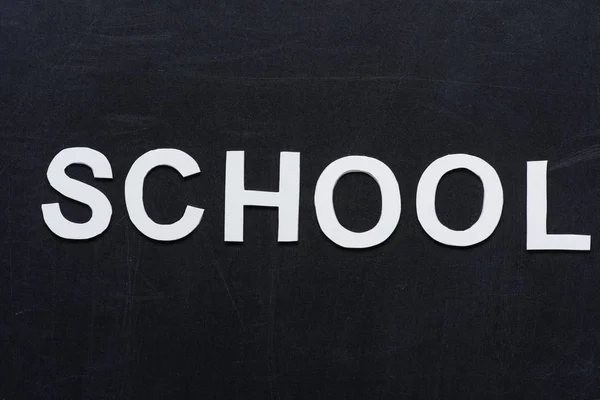 Paper letters school on chalkboard — Stock Photo