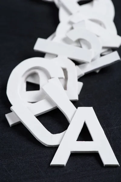Paper letters on black chalkboard — Stock Photo