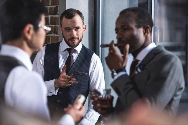 Group of businessmen smoking cigars together during break — Stock Photo