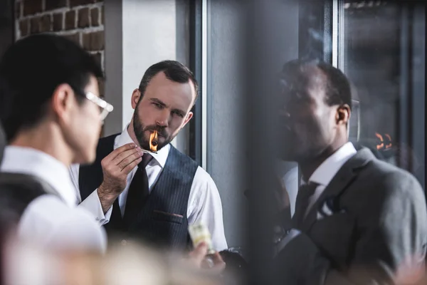 Group of businessmen smoking cigars together during break — Stock Photo