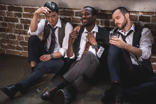Group of tired stylish businessmen resting together after work — Stock Photo