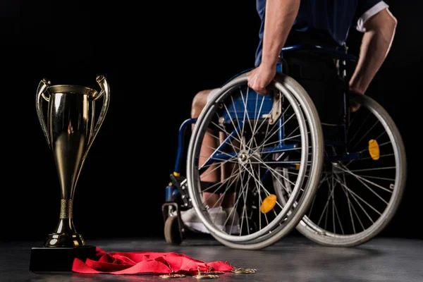 Paralympic in wheelchair with trophies — Stock Photo