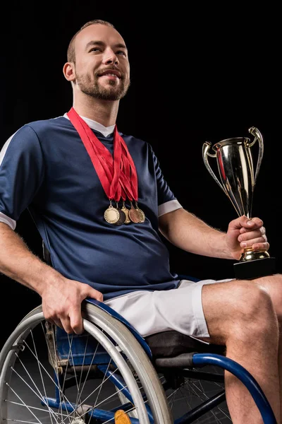 Paralympic in wheelchair with trophies — Stock Photo