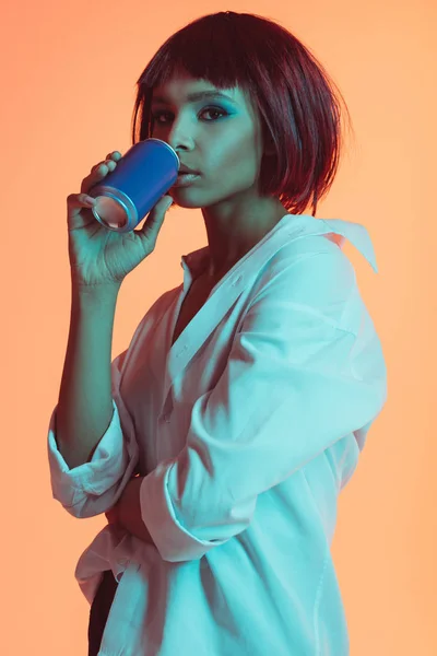 African american woman drinking from can — Stock Photo