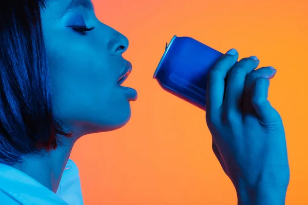 African american girl drinking from can — Stock Photo