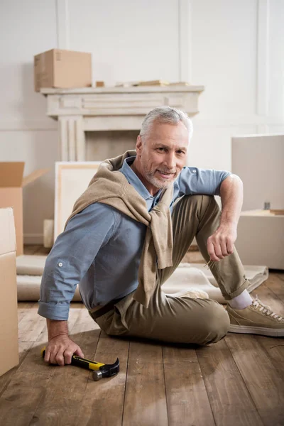 Senior man with hammer in hand — Stock Photo