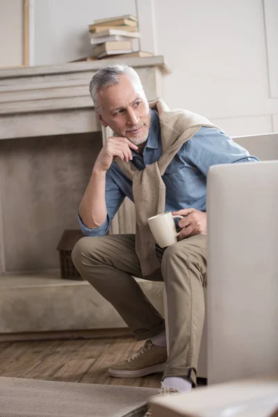 Pensive man with coffee cup — Stock Photo