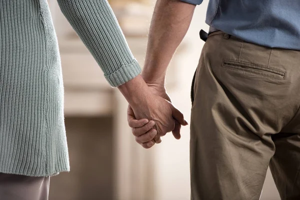 Couple holding hands at new home — Stock Photo