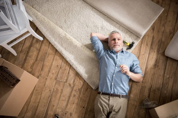 Senior man lying on floor — Stock Photo