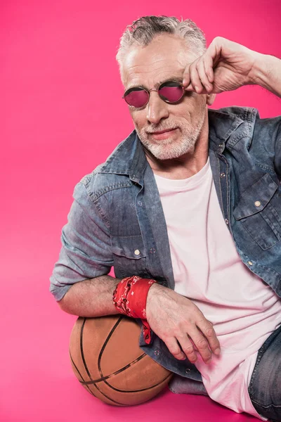 Hombre apoyado en la pelota de baloncesto - foto de stock