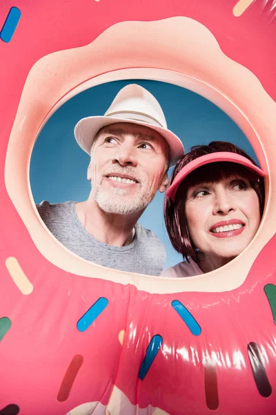 Elderly couple smiling into swimming tube — Stock Photo