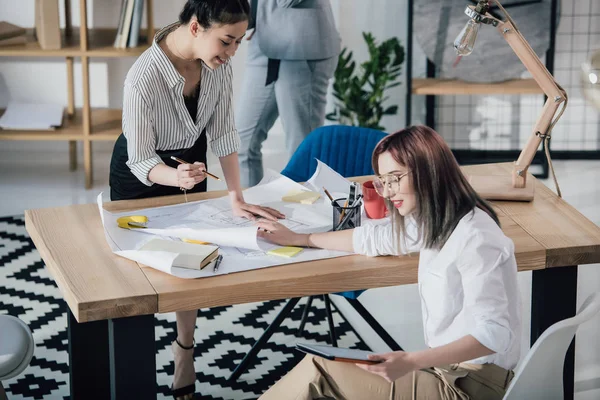 Businesswomen working with blueprints — Stock Photo