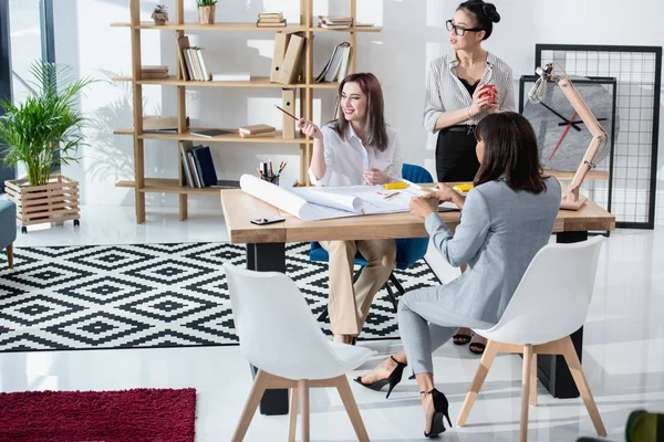 Businesswomen working with blueprints — Stock Photo