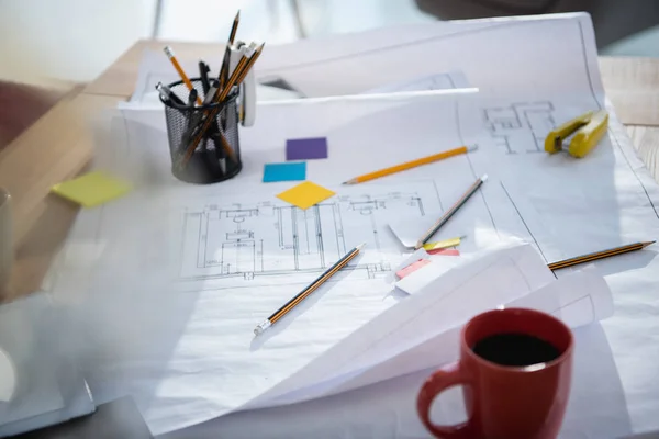 Blueprints and office supplies on table — Stock Photo