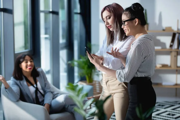Businesswomen using smartphone — Stock Photo