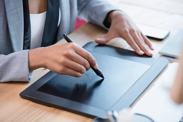 Designer drawing on graphics tablet at workplace — Stock Photo