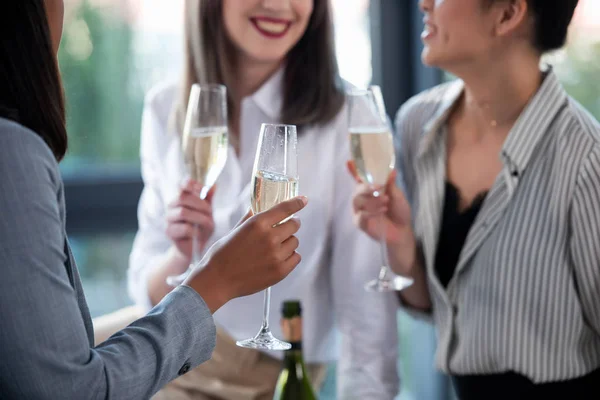 Businesswomen in formal wear drinking champagne — Stock Photo