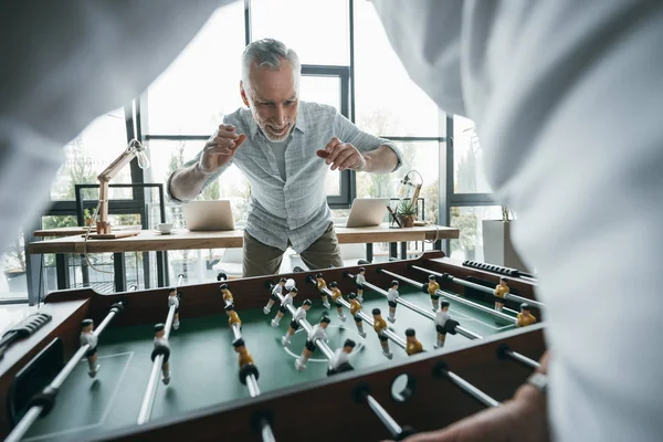 Colleagues playing foosball — Stock Photo