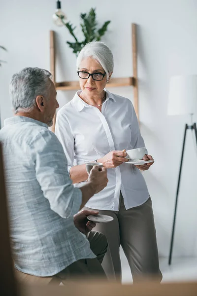 Senior colleagues converse at office — Stock Photo